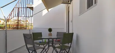 a balcony with a table and chairs and a window at Experience a nice view appartment-heart of Athens in Athens