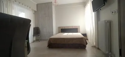 a bedroom with a bed in a room with a window at Experience a nice view appartment-heart of Athens in Athens