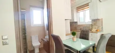 a small kitchen with a table and a toilet at Experience a nice view appartment-heart of Athens in Athens