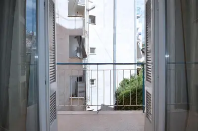 an open window with a view of a building at A heart apartment at Skouze Hill, Dirrachiou in Athens