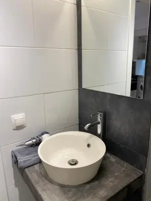 a bathroom with a white sink and a mirror at George House in Athens