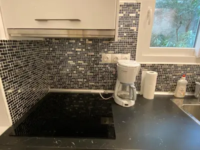 a kitchen counter with a coffee maker on a counter top at George House in Athens