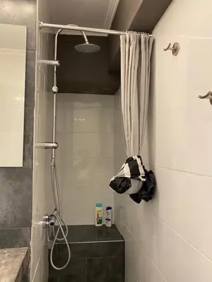 a bathroom with a shower with a shower curtain at George House in Athens