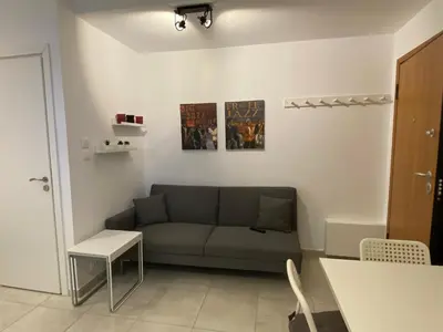 a living room with a couch and a table at George House in Athens