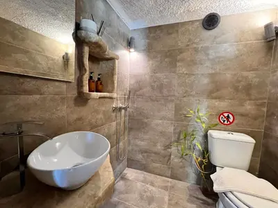 a bathroom with a toilet and a sink at Pool Villa Lagonisi 5min from Beach in Koropíon