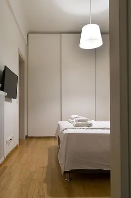 a white room with a bed and a tv at Athens Special in Athens