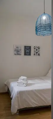 a room with a bed with a rack of towels on it at Athens Special in Athens