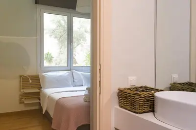 a bedroom with a bed and a window and a sink at Athens Special in Athens
