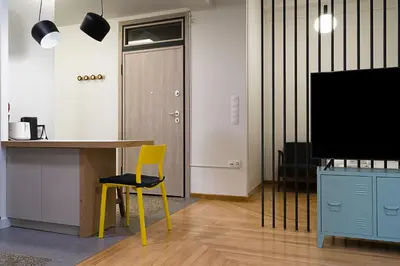 a room with a table and a yellow chair and a door at Athens Special in Athens