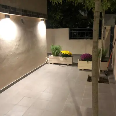 a patio with three potted plants in a building at Μία γκαρσονιέρα με γούστο για επισκέπτες με άποψη in Athens