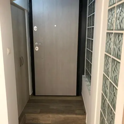 a door leading to a hallway with glass panels at Μία γκαρσονιέρα με γούστο για επισκέπτες με άποψη in Athens