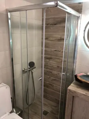 a shower with a glass door in a bathroom at Μία γκαρσονιέρα με γούστο για επισκέπτες με άποψη in Athens