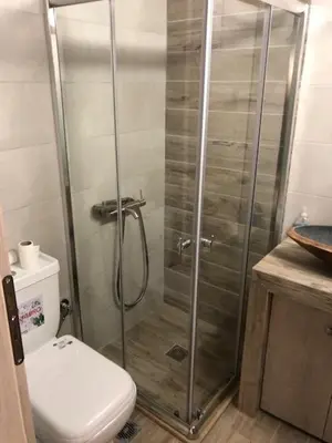 a bathroom with a shower with a toilet and a sink at Μία γκαρσονιέρα με γούστο για επισκέπτες με άποψη in Athens