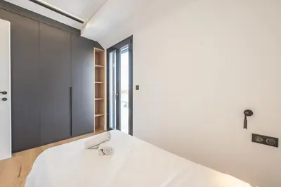 a bedroom with a white bed and a window at The 
