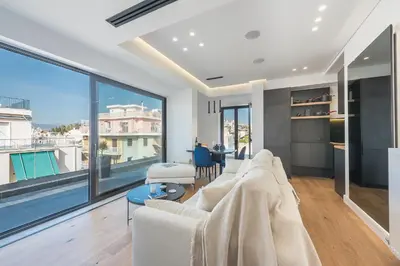 a living room with a white couch and a large window at The 