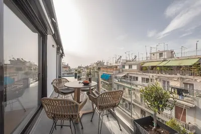 a balcony with a table and chairs and a view at The 