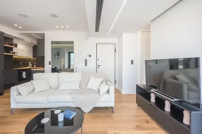 a living room with a white couch and a tv at The 