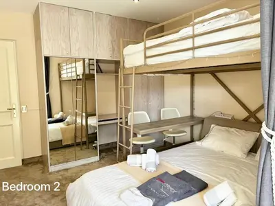 a bedroom with two bunk beds and a desk at Villasonboard 3 Bed Penthouse Veranda Beach view jacuzzi Vouliagmeni Riviera in Athens