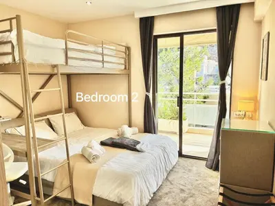 a bedroom with two bunk beds and a balcony at Villasonboard 3 Bed Penthouse Veranda Beach view jacuzzi Vouliagmeni Riviera in Athens