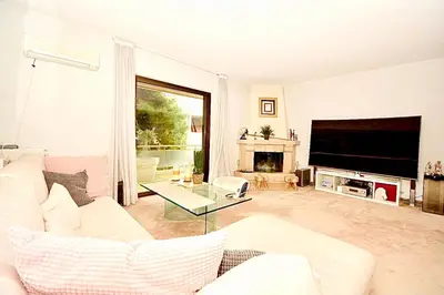 a living room with a white couch and a tv at Villasonboard 2 Bed Condo Beach Seaview Greek Riviera Vouliagmeni in Athens