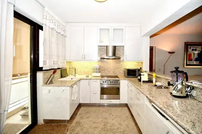 a large white kitchen with white cabinets and appliances at Villasonboard 2 Bed Condo Beach Seaview Greek Riviera Vouliagmeni in Athens