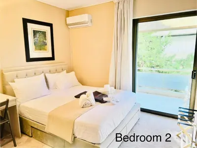 a bedroom with a bed with two towels on it at Villasonboard 2 Bed Condo Beach Seaview Greek Riviera Vouliagmeni in Athens