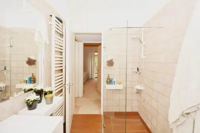 a bathroom with a walk in shower and a glass door at Villasonboard 2 Bed Condo Beach Seaview Greek Riviera Vouliagmeni in Athens