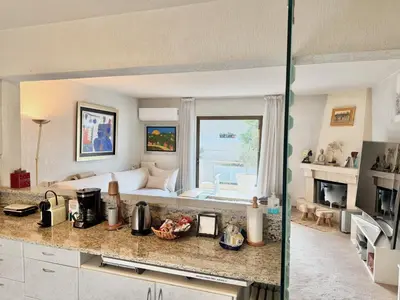 a kitchen with a living room with a couch at Villasonboard 2 Bed Condo Beach Seaview Greek Riviera Vouliagmeni in Athens