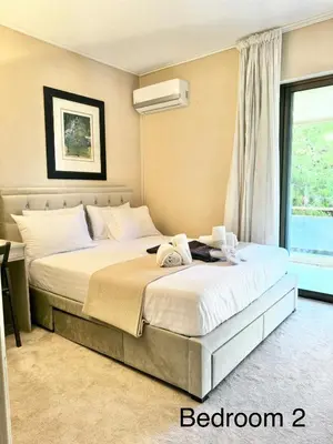 a bedroom with a large bed with a window at Villasonboard 2 Bed Condo Beach Seaview Greek Riviera Vouliagmeni in Athens