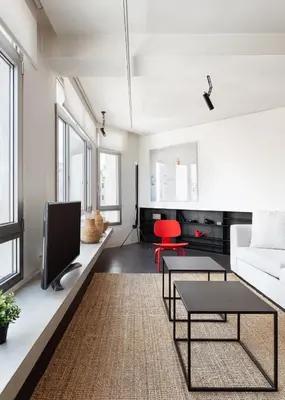 a living room with a white couch and a tv at Syntagma Designers Living in Athens