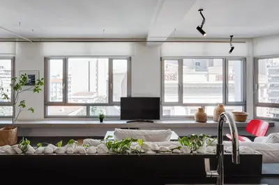 a living room with a couch and some windows at Syntagma Designers Living in Athens