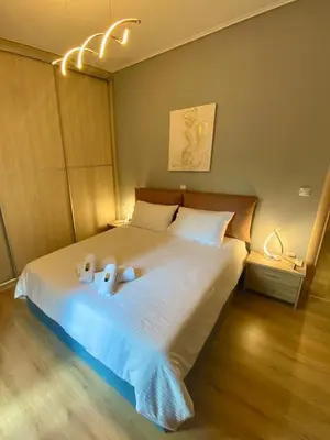 a bedroom with a bed with two teddy bears on it at Luxury suite 10’ from the center in Athens