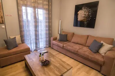 a living room with a couch and a table at Luxury suite 10’ from the center in Athens