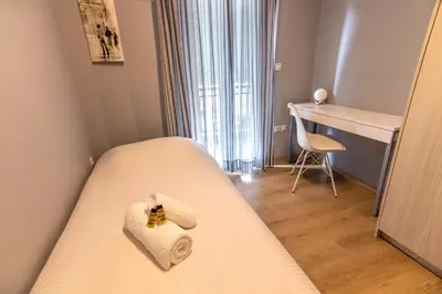 a small room with a bed with towels on it at Luxury suite 10’ from the center in Athens