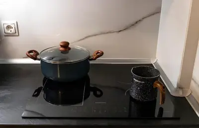 a pot on top of a stove in a kitchen at Luxury suite 10’ from the center in Athens