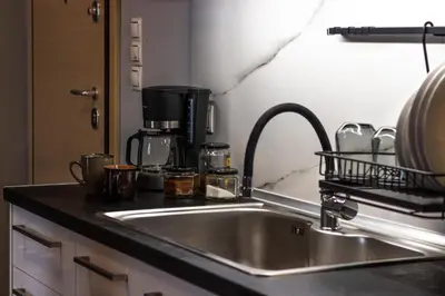a kitchen with a sink and a coffee maker at Luxury suite 10’ from the center in Athens