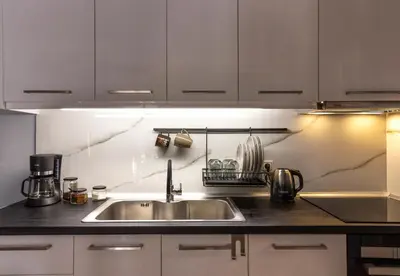 a kitchen with a sink and a counter top at Luxury suite 10’ from the center in Athens