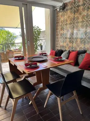 a living room with a table and a couch at So Athens - Luminous duplex apt in Plaka, Acropolis views in Athens