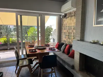 a dining room with a table and a fireplace at So Athens - Luminous duplex apt in Plaka, Acropolis views in Athens