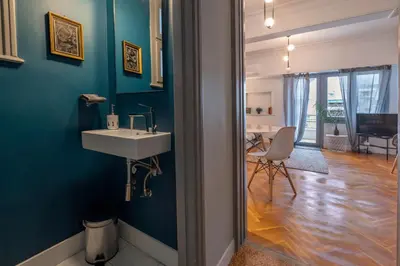 a bathroom with a sink and a blue wall at Museum Apartment - Fix B, Athens in Athens