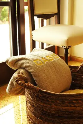 a basket with a pillow in a room with a table at Villa Oasis with Large Pool Athenian Riviera Lagonissi in Lagonissi