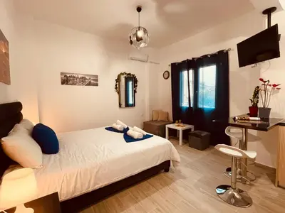 a bedroom with a bed and a desk in it at Diamond Apartment in Athens