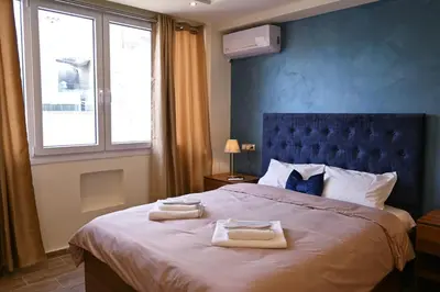 a bedroom with a large bed with towels on it at Acropolis of Athens from Ermou str in Athens