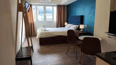 a bedroom with a bed and a table and chairs at Acropolis of Athens from Ermou str in Athens