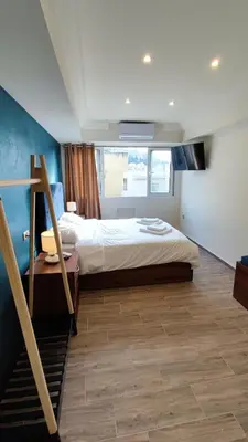 a bedroom with a bed and a staircase in it at Acropolis of Athens from Ermou str in Athens