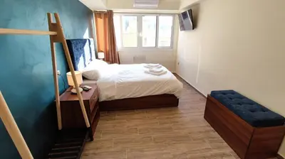 a small bedroom with a bed and a window at Acropolis of Athens from Ermou str in Athens