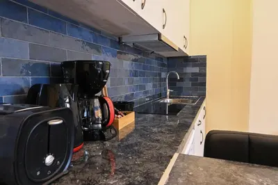 a kitchen with a coffee maker on a counter at Acropolis of Athens from Ermou str in Athens