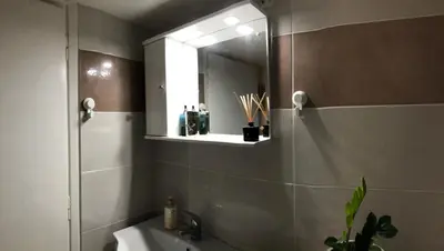 a bathroom with a shower and a sink and a mirror at Cosy apartment in Metaxourgeio in Athens