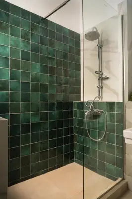 a green tiled bathroom with a shower and a toilet at Museum Apartment - Fix A, Athens in Athens