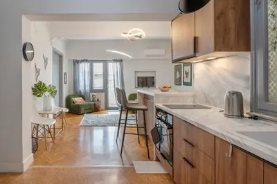 a kitchen with a counter and a living room at Museum Apartment - Fix A, Athens in Athens